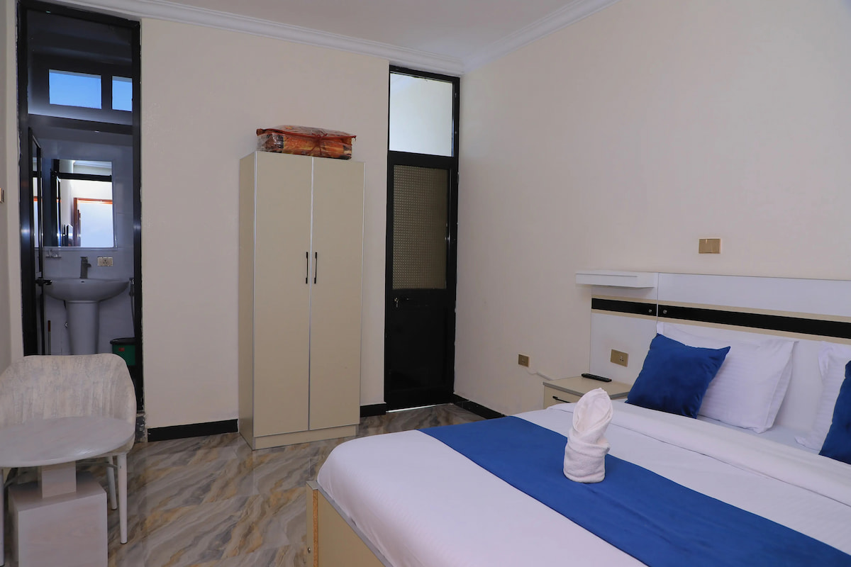 Standard Room comfortable queen bedding and warm lighting